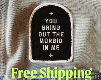May include: Black iron-on patch with white stitching and the text "You bring out the morbid in me" with a plus sign above and below the text.
