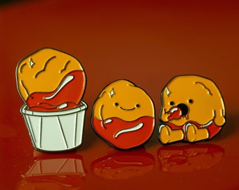 Pines de esmalte de nuggets de pollo con ketchup