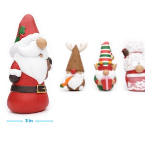 May include: A collection of Christmas gnome figurines. The Santa gnome is 5 inches tall and 3 inches wide. Other gnomes include a reindeer, an elf holding a gift, and a gnome with a white beard and red and white outfit.