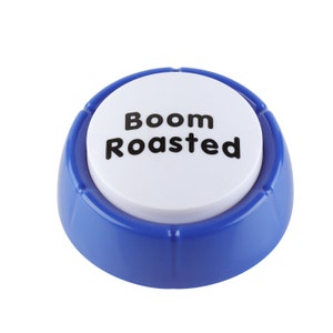 May include: A blue plastic button with a white center that says "Boom Roasted" in black text.