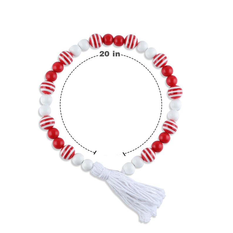 May include: A decorative beaded garland featuring red and white striped and solid beads. The garland is approximately 20 inches in length and includes a white tassel at the end. The beads are arranged in a circular shape.