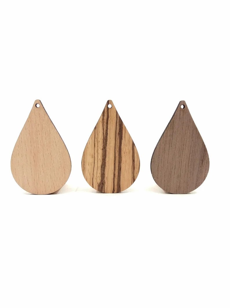 May include: Three wooden teardrop-shaped pendants in different wood finishes: light wood, striped wood, and dark wood.