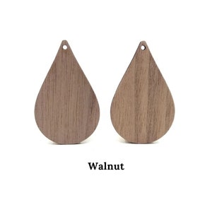 May include: Two teardrop-shaped wooden earring blanks in walnut wood.