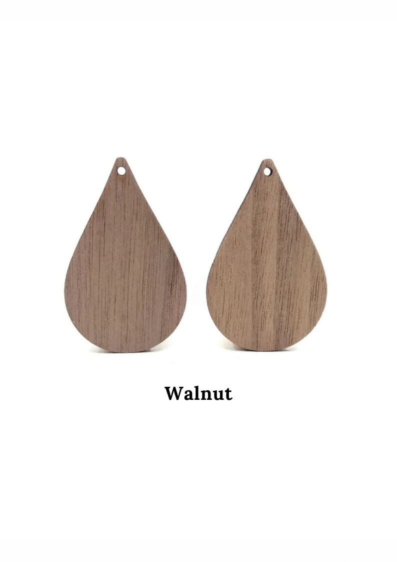 May include: Two teardrop-shaped wooden earring blanks in walnut wood.
