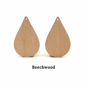 May include: Two teardrop-shaped wooden earring blanks made of beechwood.