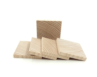 May include: Five wooden squares with a natural wood grain pattern. The squares are stacked on top of each other, with the top square slightly offset from the others.