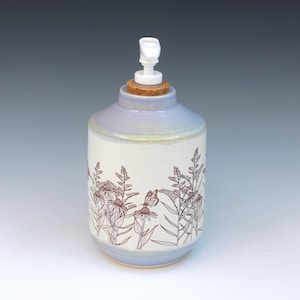 May include: A handmade, wooden cutting board with a natural wood grain. The board has a rectangular shape with rounded corners and a juice groove. The wood is a light brown color.