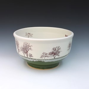 May include: A set of three ceramic mugs with a speckled, matte finish. The mugs are in shades of cream, light gray, and dark gray. Each mug has a simple, minimalist design, perfect for coffee or tea.