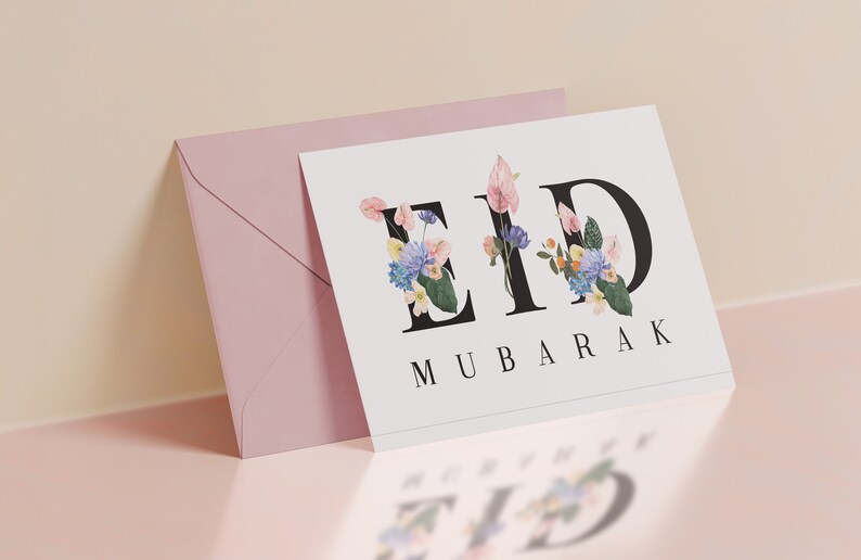 May include: A white card with the words "Eid Mubarak" in black lettering. The "Eid" is decorated with colorful flowers.