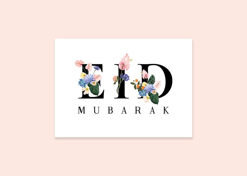 May include: A white card with the word "Eid Mubarak" written in black letters. The letters are decorated with colorful flowers.