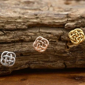May include: Three Celtic knot earrings in gold, rose gold, and silver. The earrings are small and delicate, and they are perfect for everyday wear.