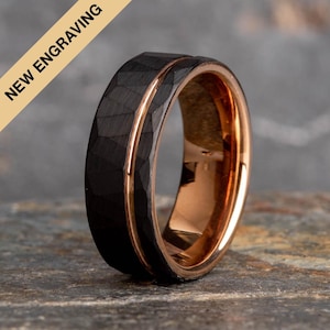 May include: A black tungsten carbide ring with a rose gold band. The ring has a hammered finish and a bevelled edge.