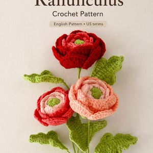 May include: A crochet pattern cover featuring three handmade ranunculus flowers in shades of red and pink, with green leaves and stems. The text "Ranunculus Crochet Pattern" is displayed at the top, with "English Pattern • US terms" below.