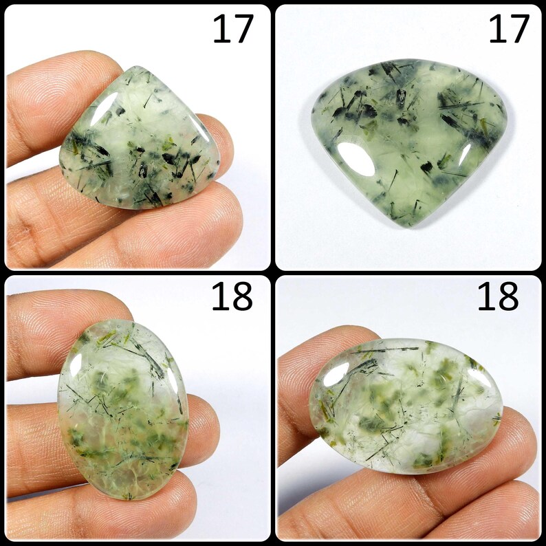May include: Four green and black gemstone cabochons, two are triangular, two are oval. The cabochons are displayed on a hand.