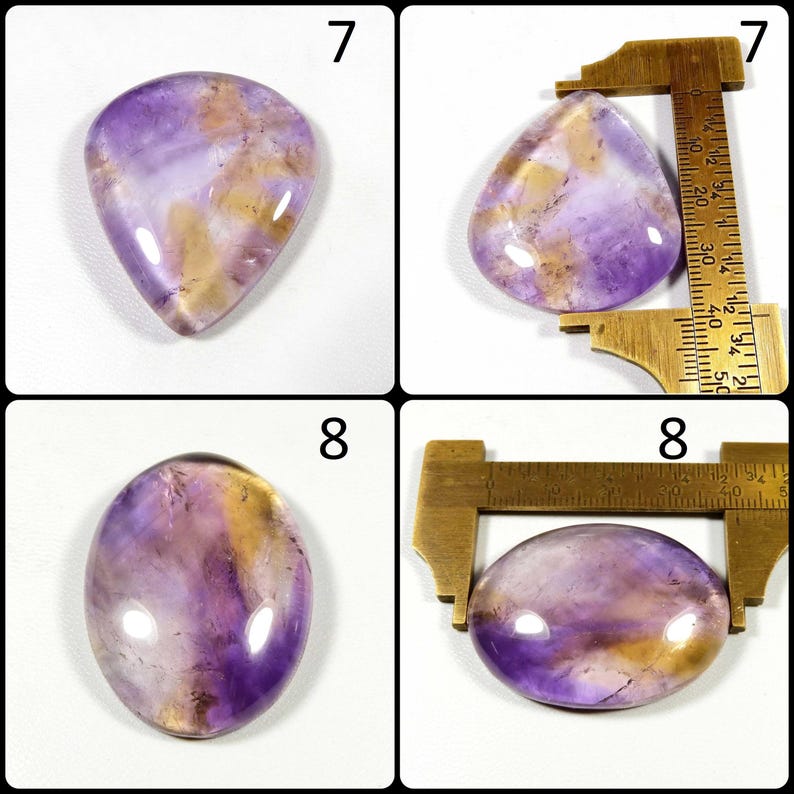 May include: Four polished gemstones with a mix of purple and gold hues. Two are teardrop-shaped, and two are oval. Measurements are shown in centimeters. The gemstones are displayed against a white background.