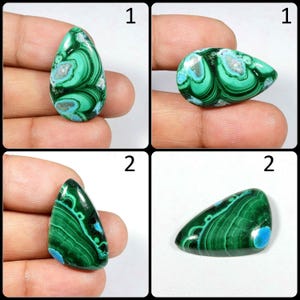May include: Two green and blue malachite cabochons, each with a unique pattern of swirls and lines. The cabochons are pear-shaped and have a smooth, polished surface.