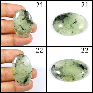 May include: Four oval-shaped green and black gemstone cabochons. The cabochons are approximately 21 mm and 22 mm in size.