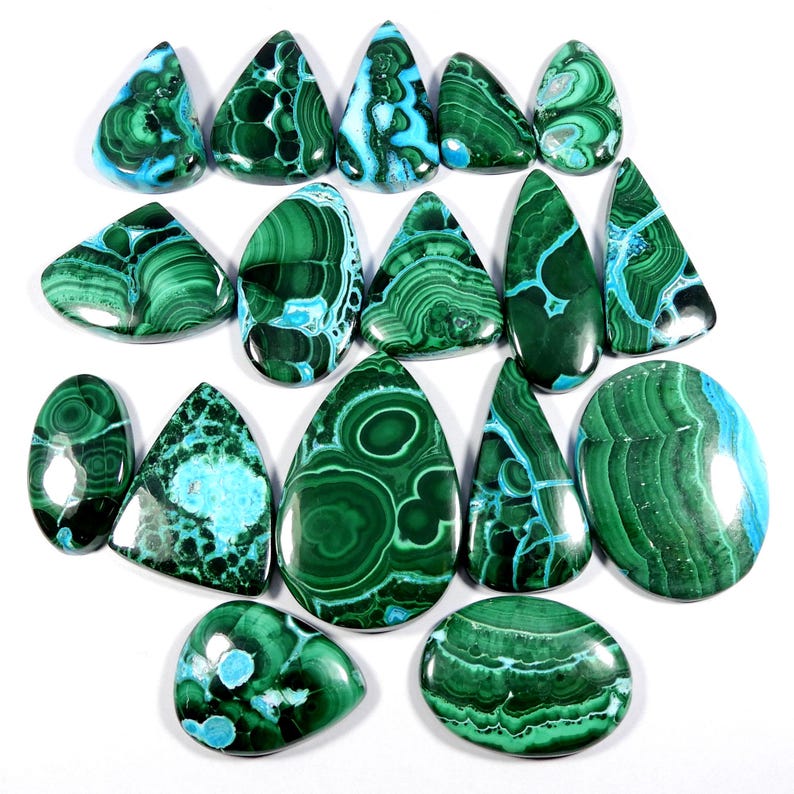 May include: A collection of 16 green and blue malachite cabochons, some with a teardrop shape and others oval, with intricate patterns and swirls.