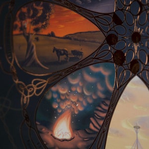 May include: A circular design with a gold border and intricate patterns. The design is divided into sections, each featuring a different scene. One section shows a sunset over a field with a horse and cart, another shows a campfire with smoke rising, and another shows a cloudy sky with stars.
