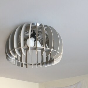 May include: A modern, gray, geometric ceiling light fixture with a circular design and multiple light bulbs.