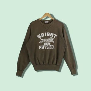 May include: A dark green sweatshirt with a white graphic of a tiger running with the text "WRIGHT 716 PHYS.ED."