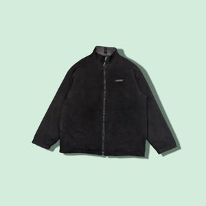 May include: A black fleece jacket with a zipper closure and a Converse logo on the chest.