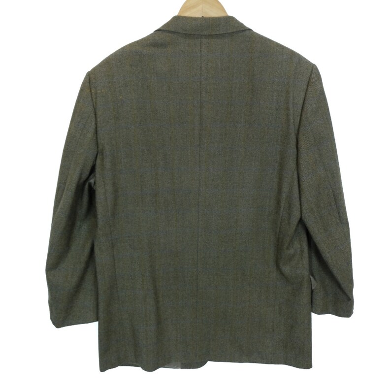 May include: A brown tweed blazer with a single button closure. The blazer has a classic fit and a slightly textured fabric.