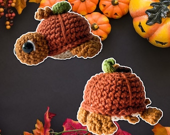 May include: Two crocheted pumpkin-shaped turtle toys. The turtles are brown and orange with a textured crocheted surface.