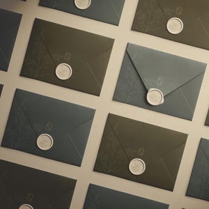 May include: A set of three ceramic nesting bowls in shades of blue, green, and white. The bowls feature a speckled glaze and a simple, modern design. The largest bowl is approximately 7 inches in diameter.