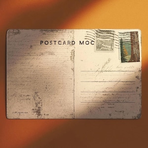 May include: A vintage postcard with the text "POSTCARD MOC" printed on the front. The postcard features a distressed, aged appearance with stamps and handwritten script. The stamps depict a deer and a forest scene.