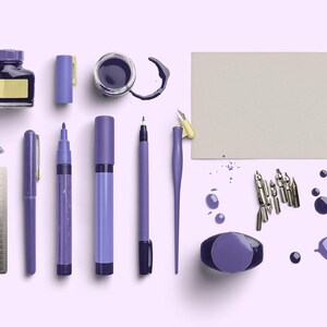 May include: An assortment of purple writing and drawing supplies, including ink bottles, pens, markers, and nibs, arranged on a light purple surface. A metal ruler and a blank card are also present. Ink splatters add a decorative touch.