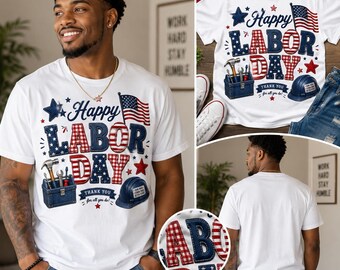 May include: A white short-sleeve t-shirt featuring a graphic print with the text Happy Labor Day. The design includes a blue toolbox with tools, a blue hard hat, an American flag, and red, white, and blue stars with plaid patterns.