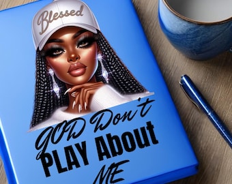 May include: A blue notebook with a graphic of a woman wearing a white baseball cap with the word "Blessed" and long braids. The text "GOD Don't PLAY About ME" is written in black. A blue pen and a blue and white mug are also visible.