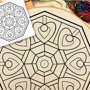 May include: A black and white mandala design with a geometric pattern of hearts and circles. The design is printed on a beige fabric and is ready to be embroidered.