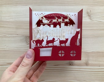 Carte Pop-up 3D de Vœux de Noel : Père Noël Survolant une Ville avec Chatons