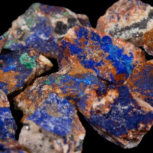 May include: Azurite and malachite rough stones in various sizes and shapes. The stones are a mix of blue, green, brown, and white.