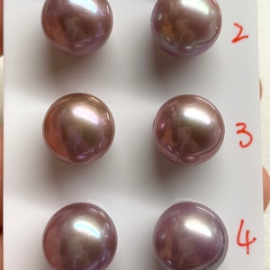 May include: Ten iridescent purple pearls arranged in rows on a white card with numbers 1 through 5 printed on the right side.