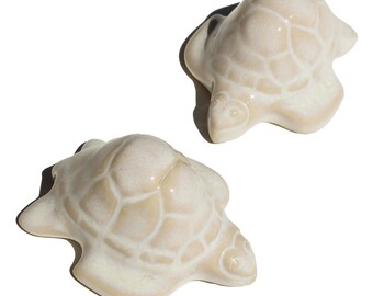 2 Sea Turtle Toilet Bolt Caps in a Beige & Opalescent White Glaze, USA made