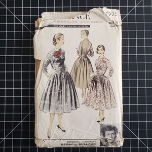 May include: Vintage sewing pattern for a dress, featuring three women wearing different styles of dresses. The pattern is labeled "American Designer" and "The Easy Printed Pattern".