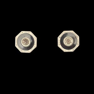 May include: A pair of octagonal shaped earrings with a black enamel background and a small clear stone in the center.