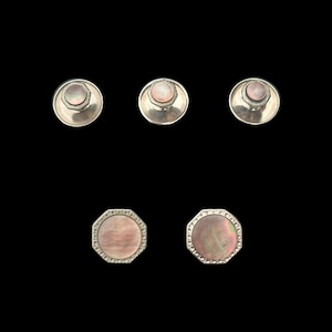 May include: Set of five silver-toned cufflinks with pink mother-of-pearl inlays. Three cufflinks have round inlays and two have octagonal inlays.