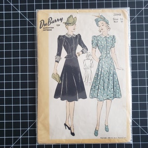 May include: Vintage sewing pattern for a dress, featuring two women wearing dresses with hats. The pattern is from Du Barry Guaranteed Patterns, number 2394B, size 16, bust 34.