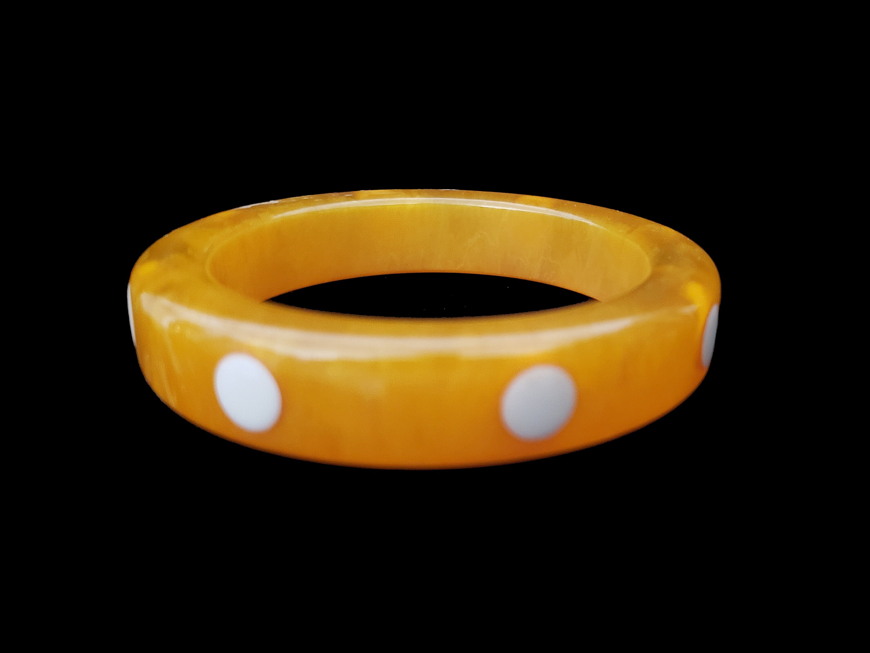 1960s White Dot Inlaid Egg Yolk Translucent Bakelite Bangle