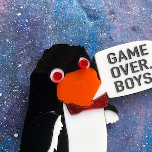 May include: A black and white penguin with red eyes and a red bow tie. The penguin is holding a white speech bubble that says "GAME OVER BOYS".