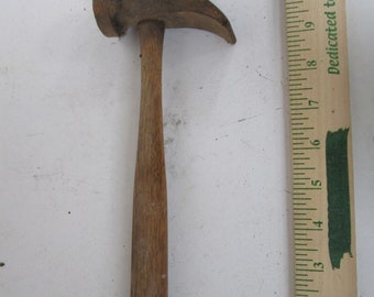 May include: A wooden-handled hammer with a metal head. The hammer is about 10 inches long.