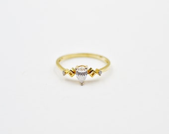 14k gold Three-Stone Trillion Ring with Pear cut Center