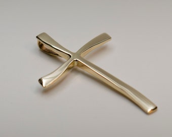 14k Gold Cross Pendant This glowing cross pendant offers a classic yet contemporary look.