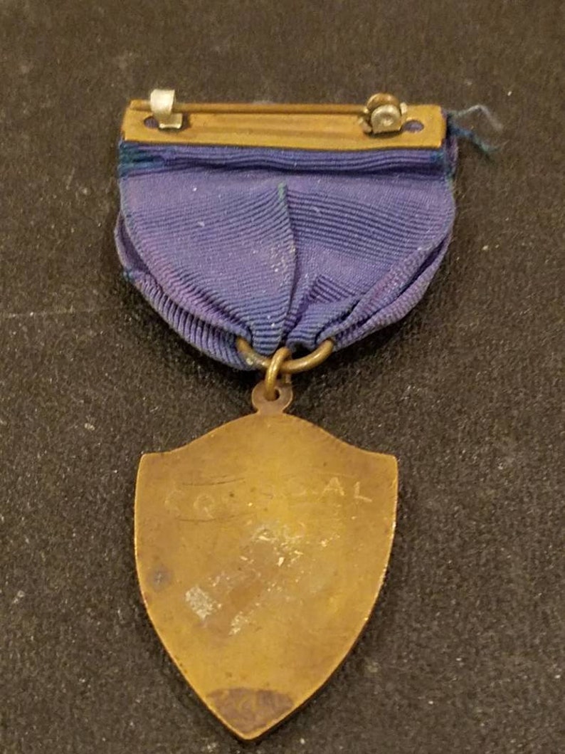 Gold color Vintage track and field medal pin intact blue ribbon Antique sports medal pin with blue ribbon.