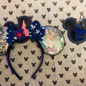 May include: A pair of purple and blue Minnie Mouse ears with a map of Disney World on one ear and a pink castle on the other. The ears are on a white background with black Mickey Mouse silhouettes.