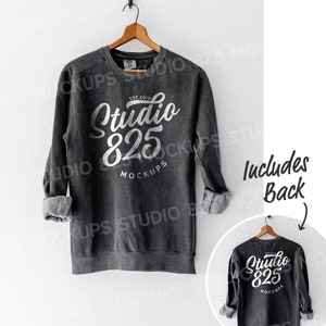 May include: A gray sweatshirt with long sleeves and a crew neck. The front of the sweatshirt has a white graphic that says "Studio 825" with the text "EST. 2019" and "MOCKUPS" underneath. The back of the sweatshirt has the same graphic.